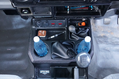 Car console with bottles and tools inside a vehicle